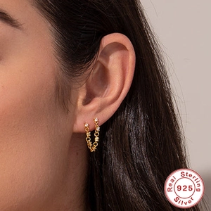 S925 sterling silver gold hoop earrings with colorful diamonds worn on a model's ear