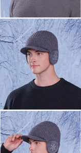 Detail of dark gray winter knit baseball cap with ear flaps and snowflake embroidery