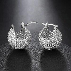 Detailed close-up of spherical pave-set cubic zirconia hoop earrings on a black background