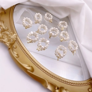 French vintage freshwater pearl ring with gold letter pendants on a retro mirror
