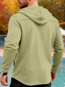 Detail view of the men's slim fit hooded trench coat featuring a curved hem and ribbed cuffs