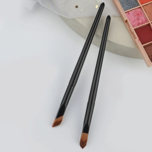 Close-up of angled concealer brush with synthetic bristles for precise contouring and makeup