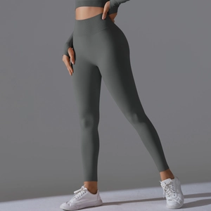 Close-up of matte dark grey high waist yoga pants and long sleeve crop top with thumb holes
