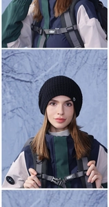 Détail du bonnet en grosse maille noire avec badge ovale pour les sports d'hiver