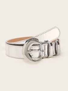 Detail of silver mirror finish belt with a moon-shaped metallic buckle on plain background