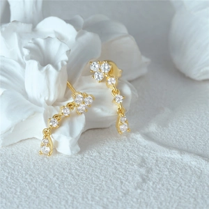 Macro view of long 18K gold S925 silver earrings with flower cluster and zircon stones