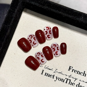 Handmade burgundy cat eye press-on nails with red leopard pattern in short square shape