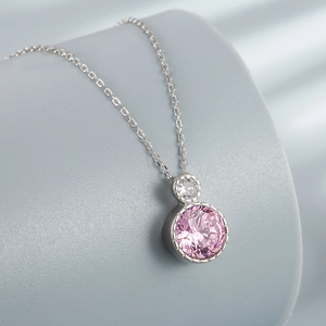 Elegant S925 sterling silver necklace with pink round diamond pendant on gray display