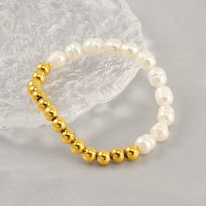 Baroque natural freshwater pearl bracelet with 18K gold plated beads on a glass tray