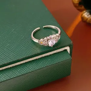 Silver crown open ring with lavender zircon and floral details on a vintage jewelry box