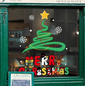 Green artistic Christmas tree and Merry Christmas static stickers on a restaurant window