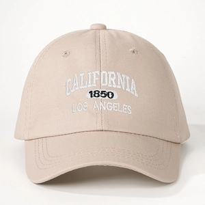 Adjustable beige cotton baseball cap with white California embroidery on white background