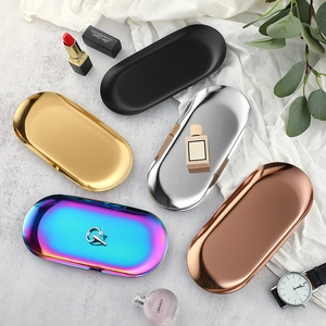 Oval stainless steel jewelry trays in gold, silver, black, rose gold, and rainbow finishes