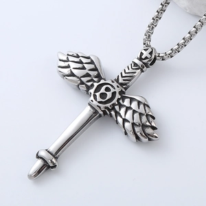 Detail of gothic silver cross wing pendant with gear element and industrial steel texture