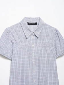 Close-up of light blue checkered poplin shirt collar with button-down front details