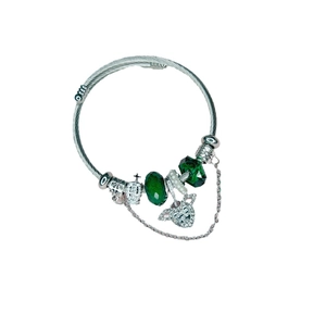 Silver twisted bangle with green crystal beads, crown charm and winged heart pendant