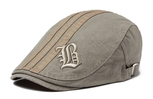Detail of grey-green beret cap with beige stripes and 3D embroidered Gothic letter B