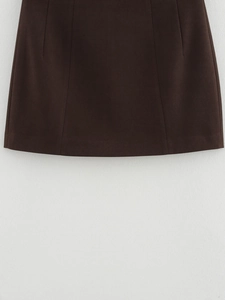 Detailed view of dark brown midi skirt with premium woven texture and clean stitching