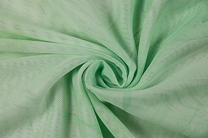 Detail of mint green mesh fabric with a spiral texture showing lightweight breathability