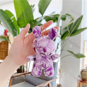 Detail of purple plush bunny keychain with geometric patterns and metal bead chain