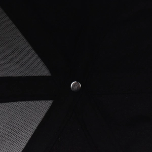 Detailed macro view of the baseball cap's top crown seam with silver metal rivet button