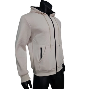 Detail view of beige zip-up hoodie featuring black zipper pockets and drawstring hood