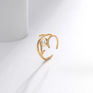 Detail view of gold branch texture ring with sparkling oval-cut zircon stone