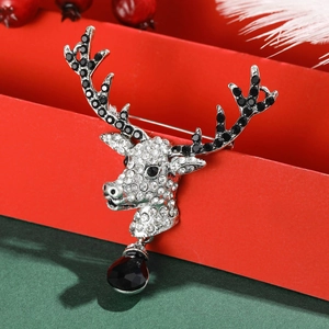 Vintage Christmas reindeer brooch with black and white crystals on red gift box background