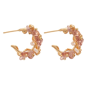 Golden C-shaped hoop earrings featuring pink strawberry crystals and small pearls