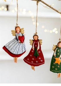 Detailed view of metal Christmas angel ornaments with jute ropes and painted details