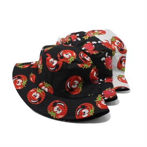 Detail view of cartoon tomato pattern stitching on black and white bucket hats