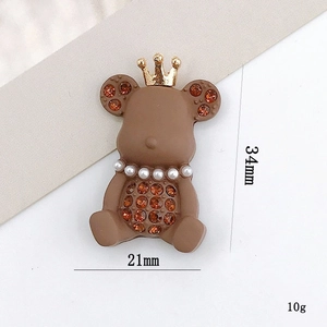 Brown crown bear accessory with orange rhinestones, 34mm height and 21mm width size view