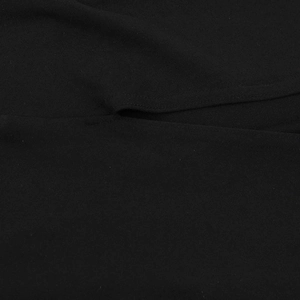 Detailed macro view of black fabric texture and split seam on this slim fit dress