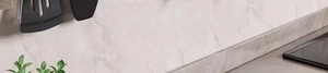 Detail showing suction cup kitchen hooks with black spatulas on marble wall background