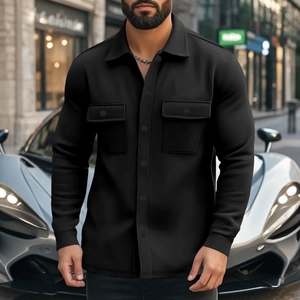 Close-up of black workwear shirt jacket featuring chest flap pockets and button front