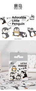 Close-up of cute cartoon penguin stickers set in a small white box for DIY journaling