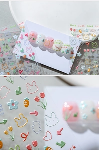 Macro detail of 3D embossed cartoon nail stickers with rabbits and tulips designs
