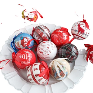 Assorted Christmas tinplate ball ornaments in decorative bowl for holiday tree decor