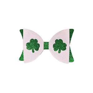Detail of pink and green glitter bow hair clip with lucky shamrock for St. Patrick's Day