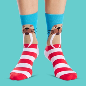 Detail of cotton crew socks featuring a brown walrus pattern and red white stripes