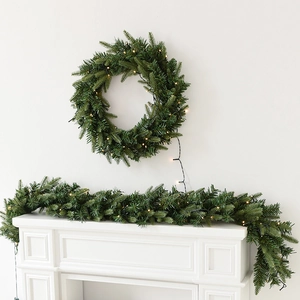 Lush green Christmas wreath and garland set with warm white LED lights for home decor