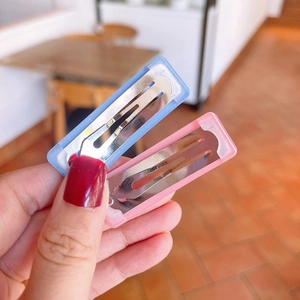 Detail of colorful plastic hair clips with metal springs in blue and pink for girls