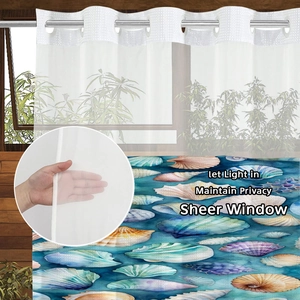 Detail of sheer shower curtain with shell prints, showing grommet top and fabric texture