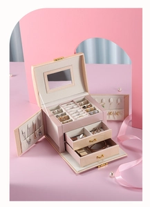 Macro view of light pink jewelry box interior with necklace hooks and velvet lining