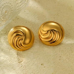 Detail of 18K gold-plated titanium steel earrings with a spiral vortex mirror finish