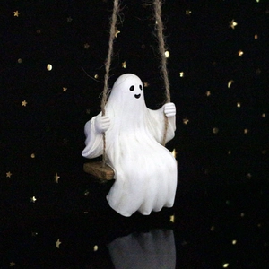 Detailed view of resin ghost sitting on a wooden swing with stars background
