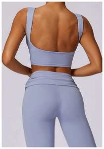 Detail of lavender yoga set featuring U-shaped open back and pleated high-waist leggings