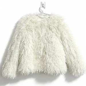 Detail view of white long-haired faux fur coat with round neck and premium texture