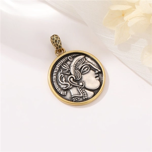 Macro shot of Roman portrait relief pendant in vintage metal on white silk backdrop