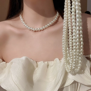 Macro view of lustrous white pearls on a layered necklace showcasing fine texture